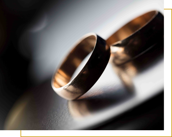 A close up of two wedding rings on top of a table.